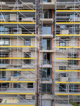 Scaffolding on Building Facade Under Construction for Renovation Work Stock Photos