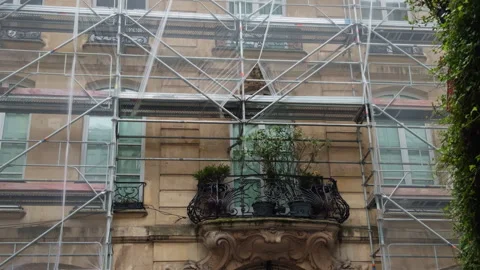 Scaffolding Enveloping a Historic Building That Features a Balcony and Abundant Stock Footage 318555636