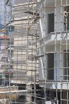 Scaffolding on multi storey building facade during facade renovation. Brigh.. Stock Photos