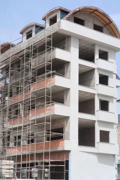 Scaffolding on multi storey building facade during facade renovation. Brigh.. Stock Photos