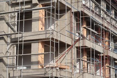 Scaffolding on multi storey building facade during facade renovation. Brigh.. Stock-Fotos