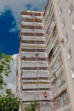 Scaffolding on a multistory building. Warming of the outer wall panel. A work Stock Photos
