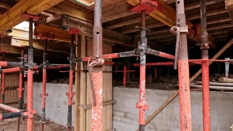 Scaffolding is set up to back prop against form work to support a concrete cast Stock Footage 301069403