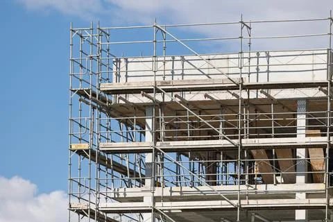 Scaffolding supporting concrete structure during building construction Stock Photos