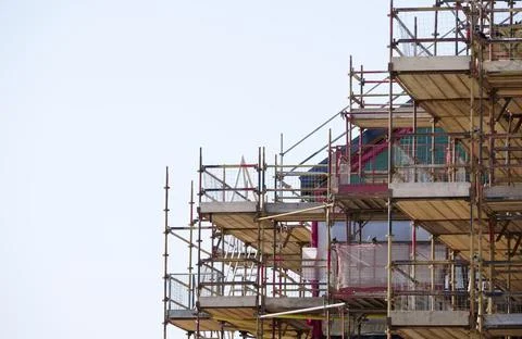 Scaffolding surrounding house development for safe access to construction work Stock Photos