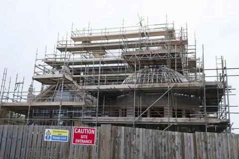 Scaffolding surrounding house development for safe access to construction work Stock Photos
