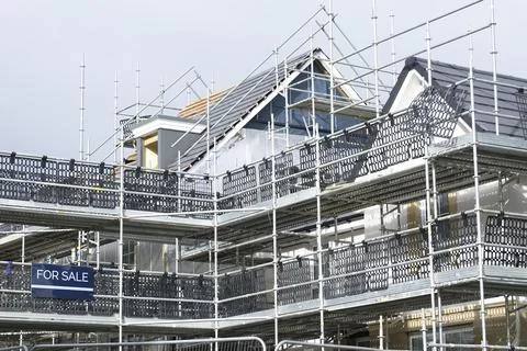 Scaffolding surrounding house development for safe access to construction work Stock Photos