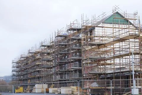 Scaffolding surrounding house development for safe access to construction work Stock Photos