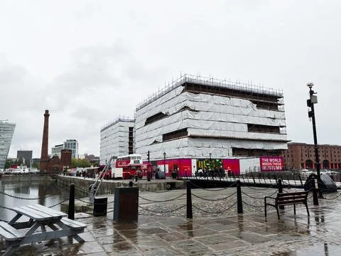 Scaffolding wrapped waterfront building under renovation at Liverpool, UK d.. Stock Photos