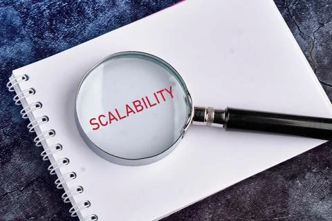 SCALABILITY word concept on a blank page of a notebook through a magnifying g 스톡 사진