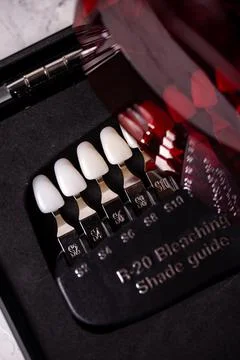 A scale for checking the color of teeth in close-up. Cosmetic dentistry Stock Photos