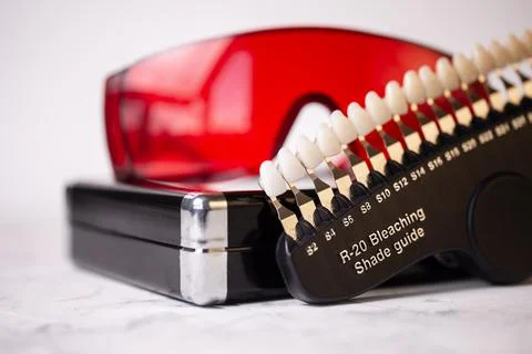 A scale for checking the color of teeth in close-up. Cosmetic dentistry Stock Photos