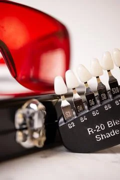 A scale for checking the color of teeth in close-up. Cosmetic dentistry Stock Photos