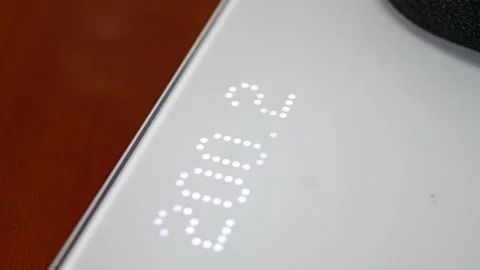 Scale display shows high weight, highlighting extreme obesity. Stock Footage 321750184