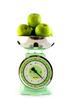 Scale for the kitchen with green apples Stock Photos