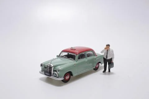 A scale man miniature figure with taxi Stock Photos