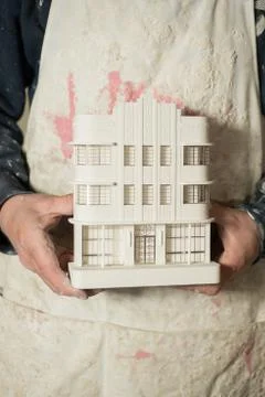Scale Model of Architectural Building Held by Two Hands Stock-Fotos