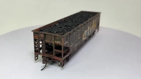 Scale model of coal hopper wagon railroad car with weathering effects Stock Footage 329244169