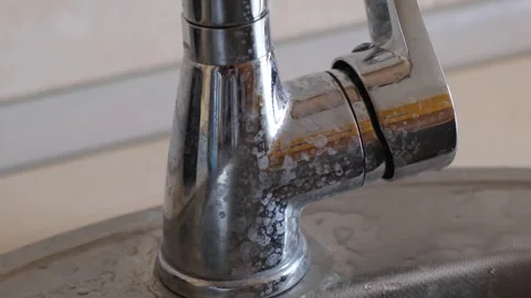 Scale or deposits on the faucet from hard water. Limescale deposits on the water Stock Footage 273857853