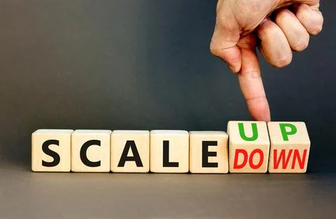 Scale up or down symbol. Concept words Scale up Scale down wooden cubes. Busi Stock Photos