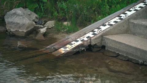 Scale at shore of river to measure water level, which is very low on this pho Stock Footage 301999260