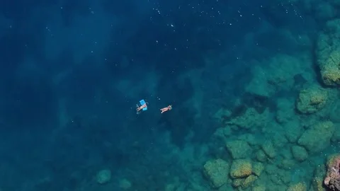 Scalea, Italy, September 23, 2025: Swimmers Exploring Clear Waters Among Rocky Stock Footage 317765948