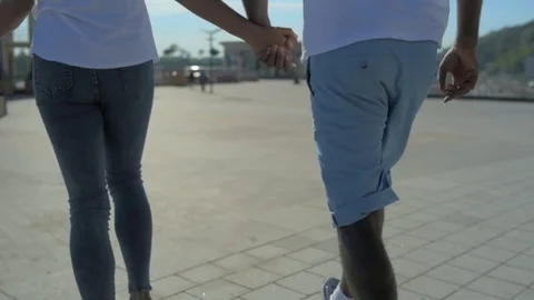 Scaled up of young couple running with hand in hand Stock Footage