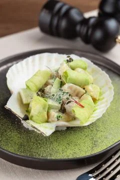 Scallop salad with avocado, served in a shell  luxury delicatessen starter in Stock Photos