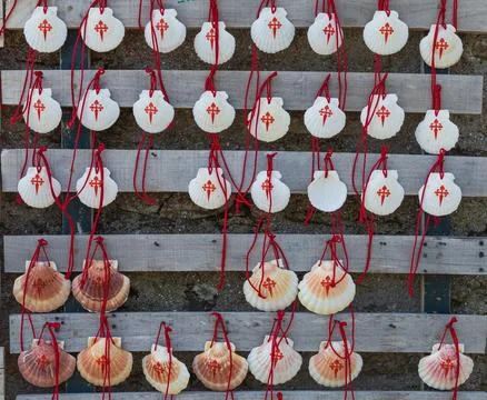 Scallop shell with red cross, which pilgrims carry on Camino de Santiago, Spain. Stock Photos