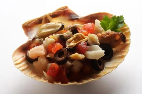 Scallop shell with seafood inside Stock Photos