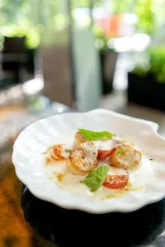 Scallop with tomatoes and sauce and basil Stock-Fotos