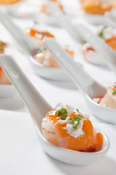 Scallops served on spoon. Stock Photos