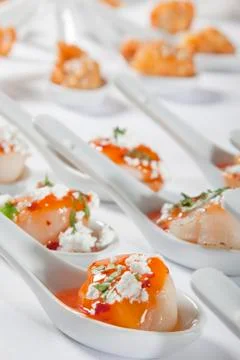 Scallops served on spoon. Stock Photos