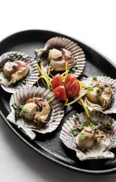Scallops in shell seafood tapas portion in barcelona restaurant spain Stock Photos
