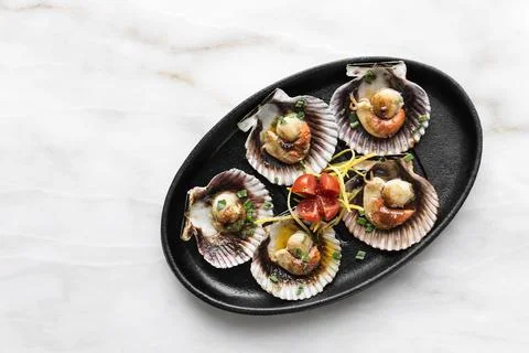 Scallops in shell seafood tapas portion in barcelona restaurant spain Stock Photos