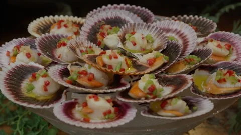Scallops in Their Shells With Pepper Salsa on a Buffet Stock Footage 348952564