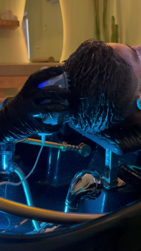 Scalp massage device with blue light in salon, vertical close-up Stock Footage 345165176