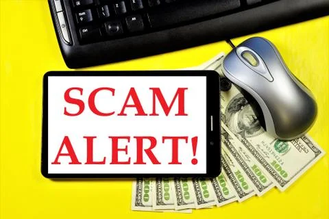 Scam alert-a message on the tablet computer screen. Stock Photos
