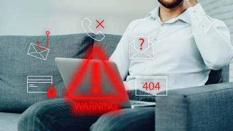 Scam call and SMS alert received by a person sitting on a couch with a laptop Stock Photos