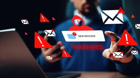 Scam call sms message alert on smartphone while using a laptop in a dim room Stock Photos