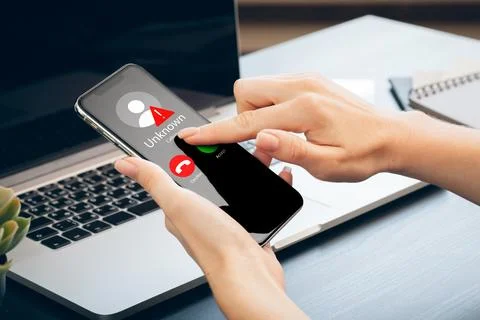 Scam call SMS message displayed on a smartphone with unknown caller ID at a Stock Photos