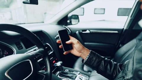 Scam call text message received while driving in a car Stock Photos