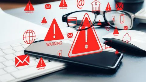 Scam call text message warning on smartphone screen with computer and glasses Stock Photos