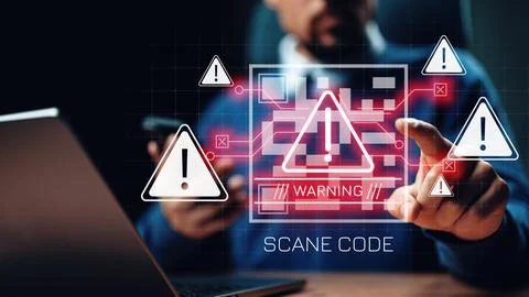 Scam call warning alert received on mobile phone while using a laptop Stock Photos
