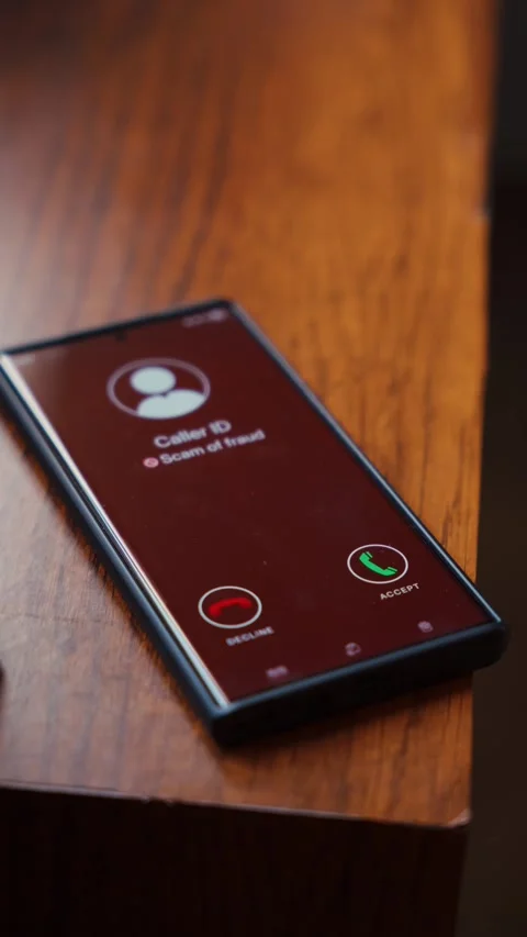 Scam Call Warning on Smartphone Screen Lying on Wooden Table. Stock Footage 344677884