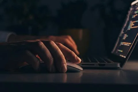 Scam message alert on computer screen during late-night work session Stock Photos