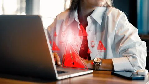 Scam message appearing on laptop during online session in home office space Stock Photos