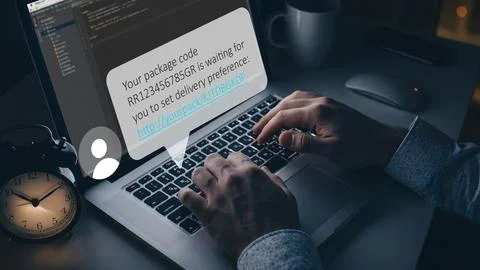Scam message displayed on a computer screen while someone types on a laptop Stock Photos
