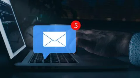 Scam message warning about phishing emails received on a laptop screen at night 写真素材