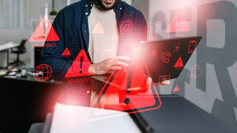 Scam message warning on a laptop screen in an office environment Foto stock